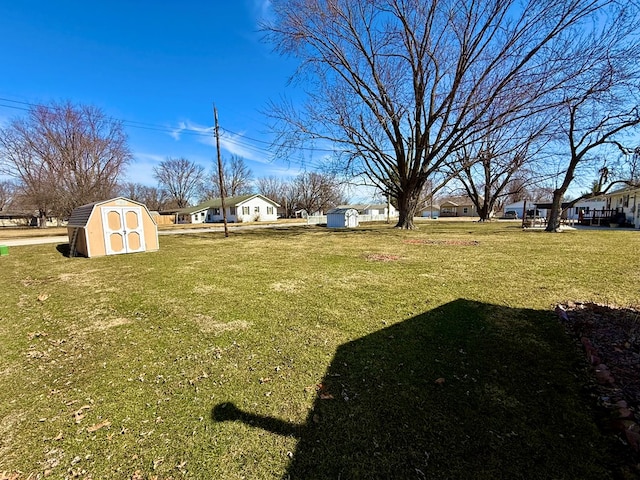 view of yard featuring a storage unit and an outdoor structure