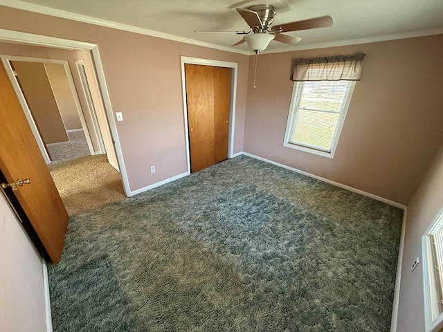 unfurnished bedroom with crown molding, ceiling fan, baseboards, carpet, and a closet