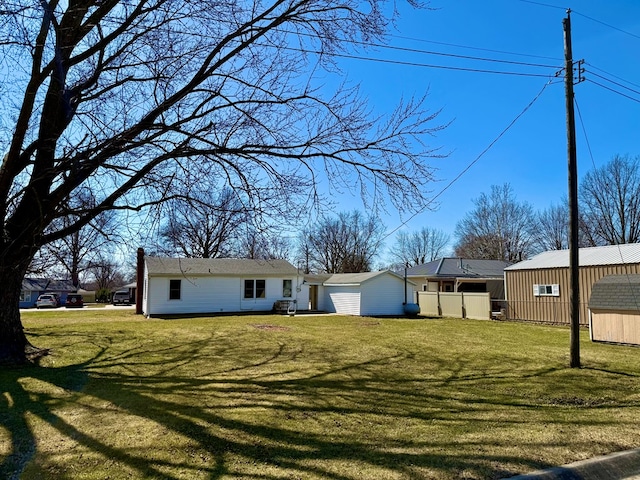 view of yard with an outbuilding, a storage unit, and a garage