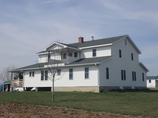 back of house with a yard