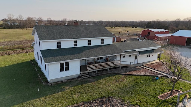 exterior space featuring a lawn, an outbuilding, and a deck