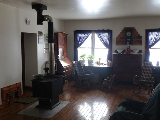 office area featuring a wood stove and dark hardwood / wood-style floors