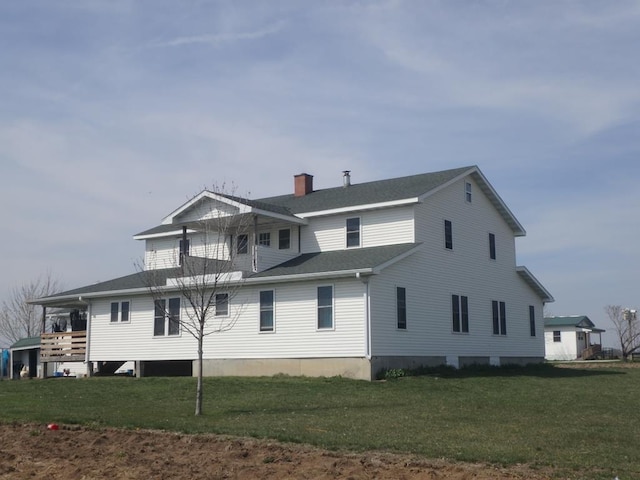 rear view of house with a lawn