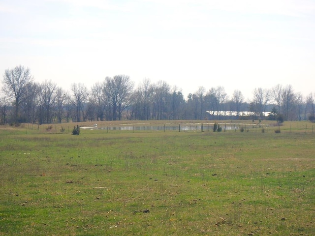 view of yard featuring a rural view and a water view