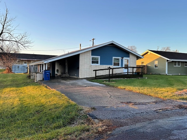 view of front of property with a front lawn, a deck, and a carport