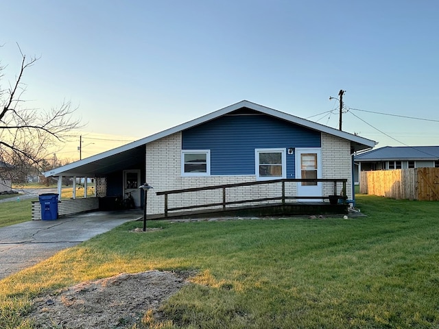 view of front of property with a yard and a carport