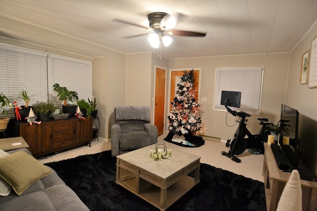 living area featuring carpet and ceiling fan