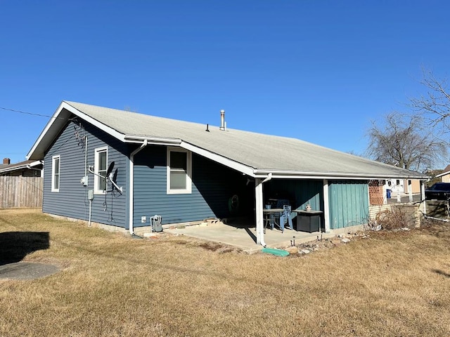 back of house with a patio, a lawn, and fence