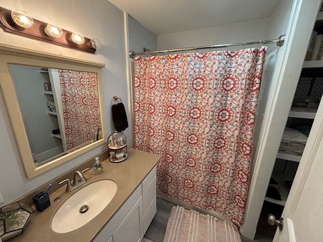 712 W Shelby, Kirksville, MO 63501 - full bathroom with vanity, a shower with curtain, and wood finished floors