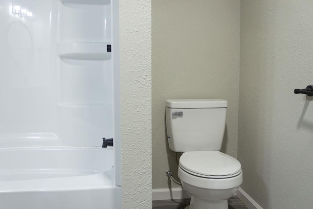 bathroom featuring hardwood / wood-style flooring and toilet