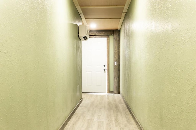 corridor featuring wood ceiling, a wall unit AC, and light hardwood / wood-style flooring