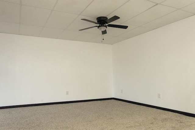 spare room featuring carpet flooring, a paneled ceiling, and ceiling fan