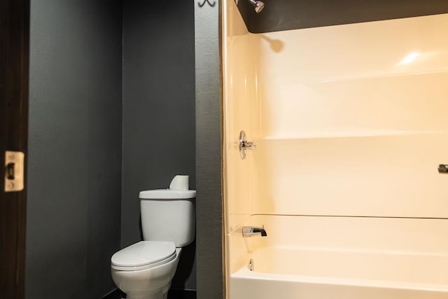 bathroom featuring bathtub / shower combination and toilet