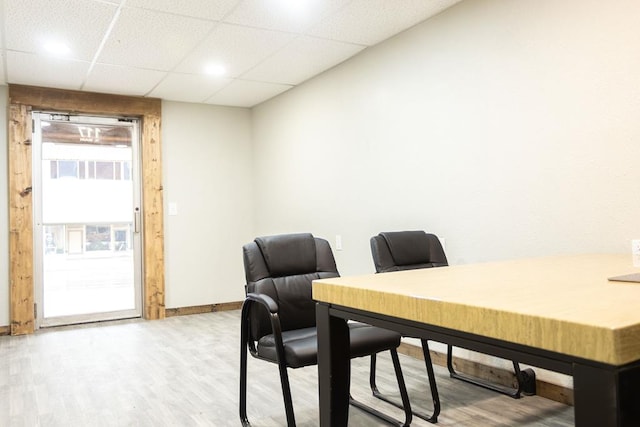 office featuring wood-type flooring and a paneled ceiling