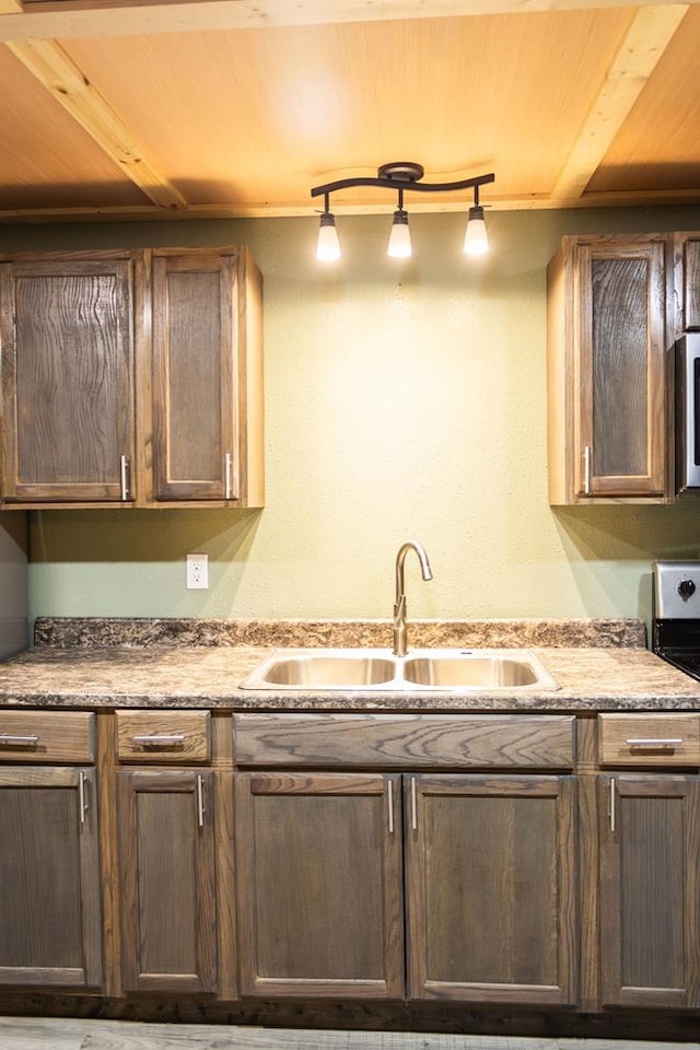 kitchen with rail lighting, wood ceiling, and sink