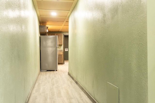 corridor with light hardwood / wood-style flooring