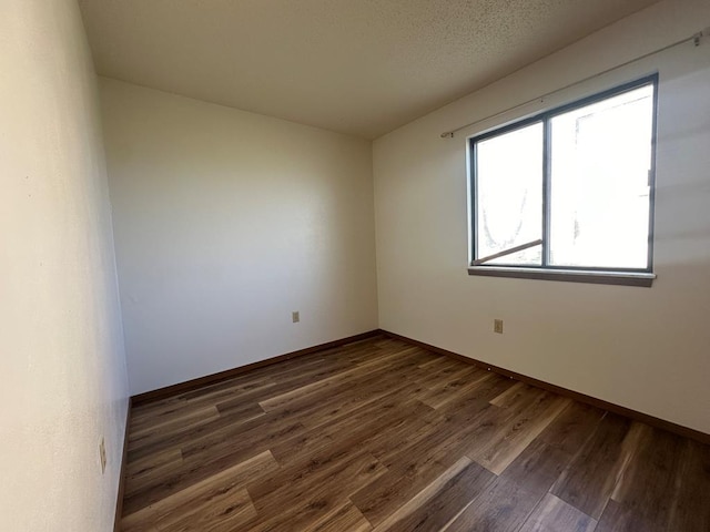 empty room featuring dark hardwood / wood-style floors