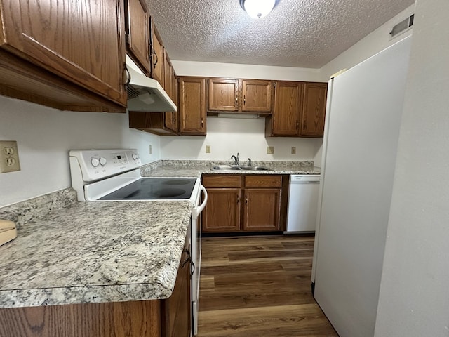 2703 Woodwinds Ct, Kirksville, MO 63501 - kitchen with dark hardwood / wood-style flooring, white appliances, a textured ceiling, and sink