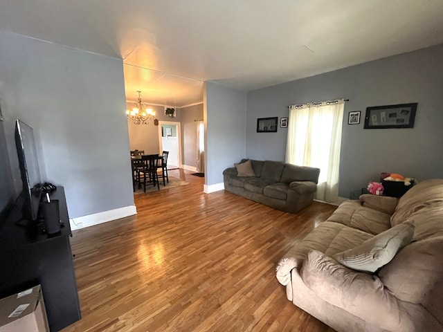 432 Woodrow, Chillicothe, MO 64601 - living room featuring baseboards, wood finished floors, and a chandelier
