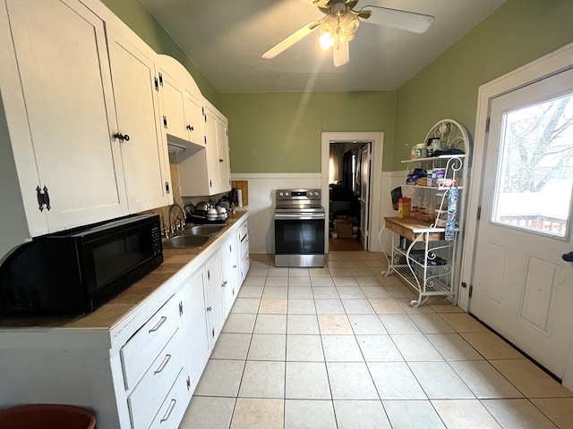 432 Woodrow, Chillicothe, MO 64601 - kitchen featuring black microwave, electric stove, white cabinets, and a sink