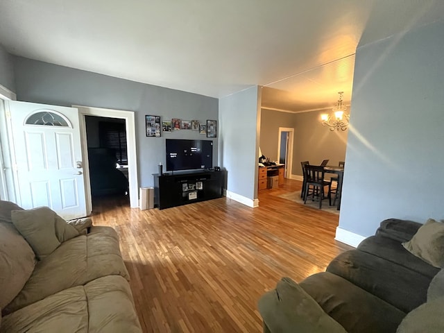 432 Woodrow, Chillicothe, MO 64601 - living room featuring baseboards, light wood-type flooring, and a chandelier