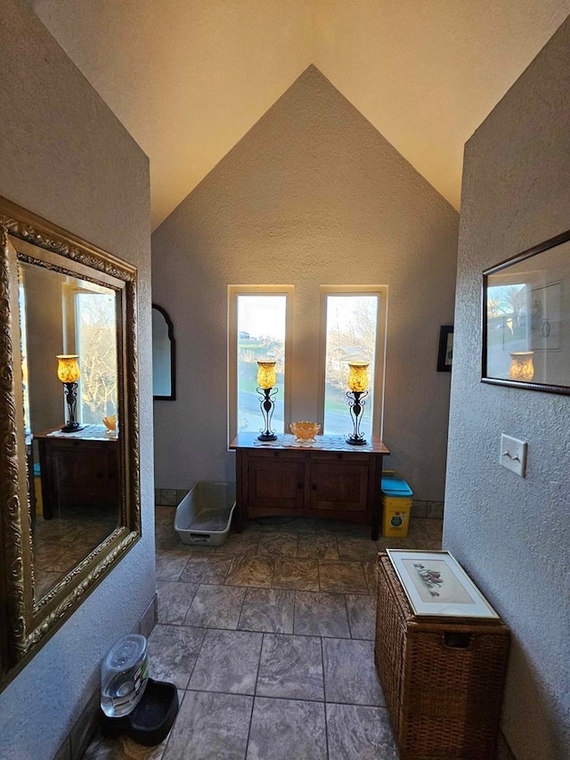 bathroom with high vaulted ceiling