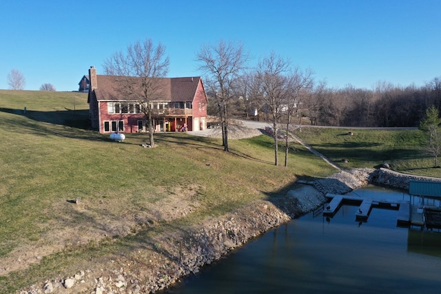 rear view of property featuring a yard