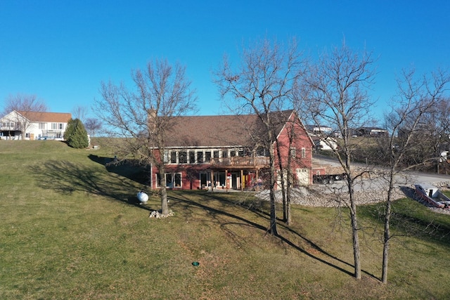 back of property featuring a deck and a yard