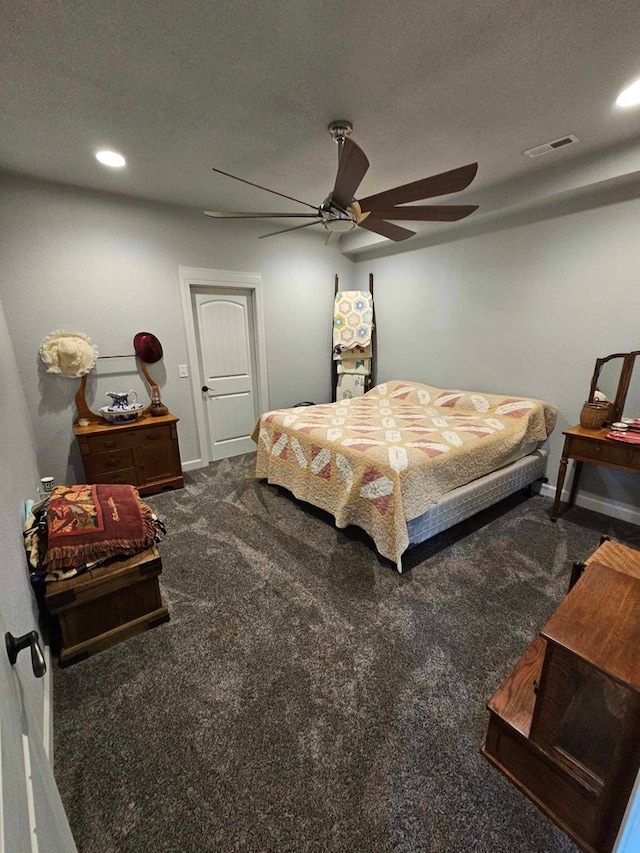 bedroom with ceiling fan and dark carpet