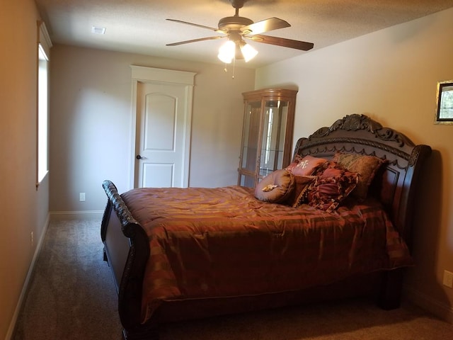 bedroom featuring ceiling fan and dark colored carpet