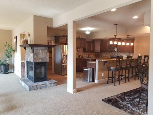 interior space with light colored carpet and a fireplace