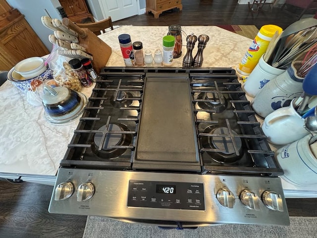 53895 E 3rd St, Milan, MO 63556 - interior details with gas range oven, cooktop, and wood finished floors