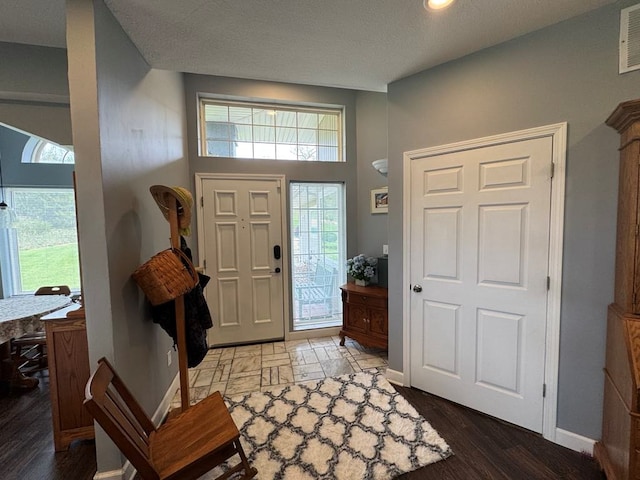 53895 E 3rd St, Milan, MO 63556 - foyer featuring wood finished floors, visible vents, and baseboards