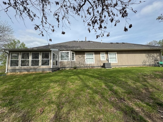 53895 E 3rd St, Milan, MO 63556 - back of property with central AC, a yard, and a sunroom