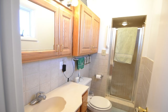 bathroom featuring tile walls, walk in shower, vanity, and toilet