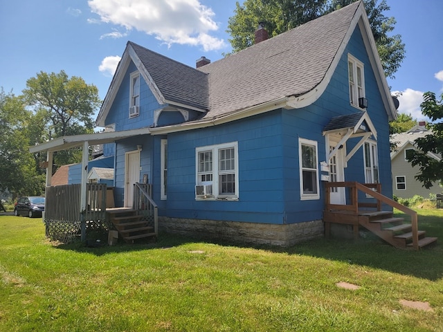 410 E Buchanan, Kirksville, MO 63501 - view of front of home with a chimney, a front yard, and roof with shingles