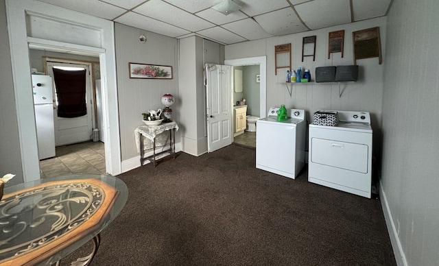 410 E Buchanan, Kirksville, MO 63501 - laundry room featuring washer and dryer, dark colored carpet, and baseboards