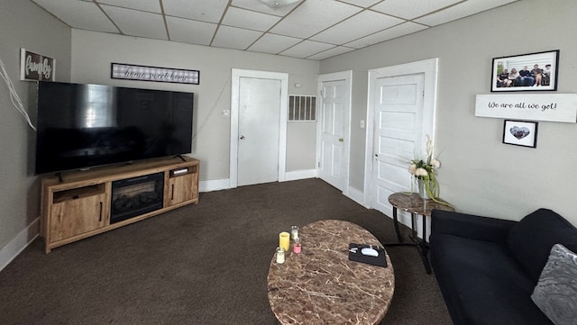 410 E Buchanan, Kirksville, MO 63501 - carpeted living area featuring a paneled ceiling and baseboards