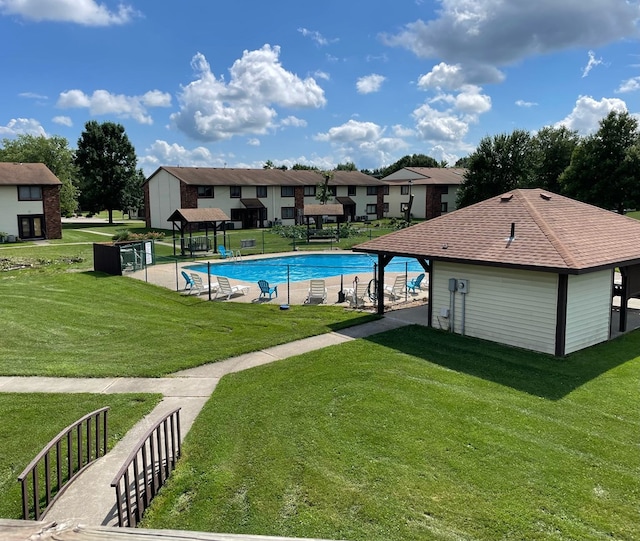 view of pool featuring a lawn