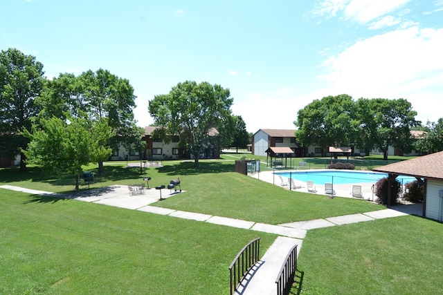 view of swimming pool featuring a lawn