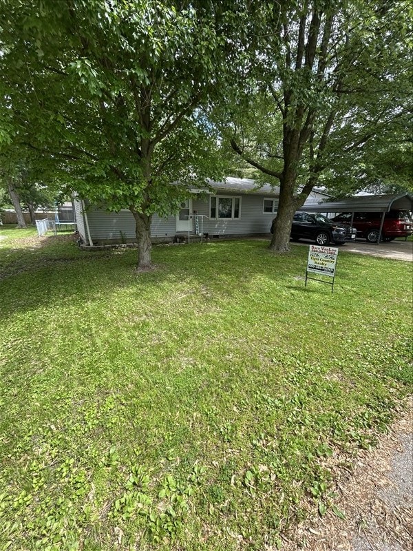 116 Adams St, Centralia, MO 65240 - view of green lawn featuring a detached carport