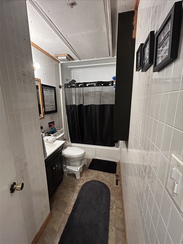 116 Adams St, Centralia, MO 65240 - full bath featuring tile walls, vanity, a textured ceiling, toilet, and tile patterned flooring