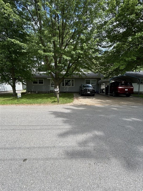 116 Adams St, Centralia, MO 65240 - view of front of home with driveway, a carport, and a front yard