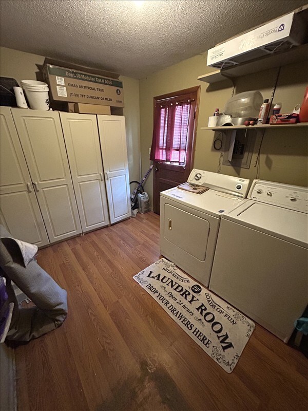 116 Adams St, Centralia, MO 65240 - laundry area with a textured ceiling, washer and dryer, and light wood-style floors