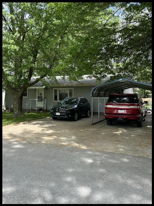 116 Adams St, Centralia, MO 65240 - view of parking featuring driveway and a carport