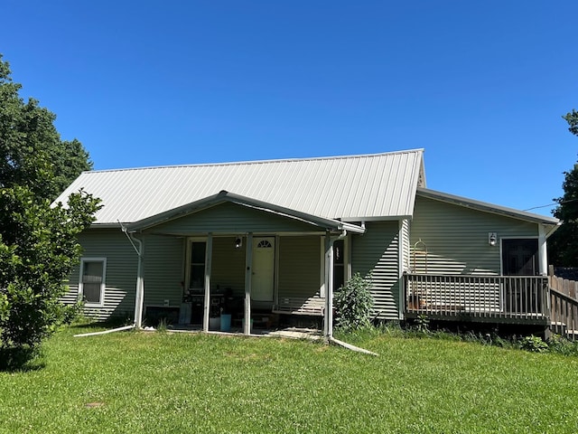 back of property with a lawn