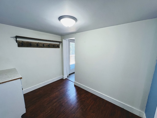 unfurnished room with dark hardwood / wood-style floors