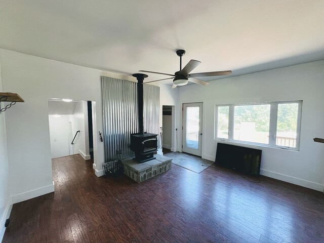 unfurnished living room with ceiling fan and dark hardwood / wood-style flooring