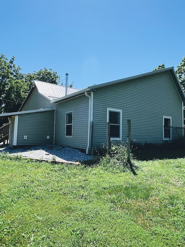 back of property featuring a lawn