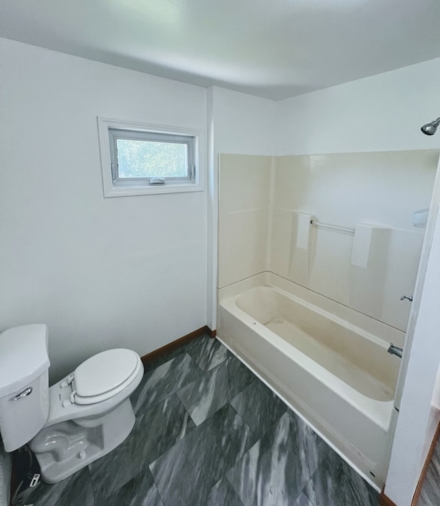 bathroom with bathtub / shower combination and toilet